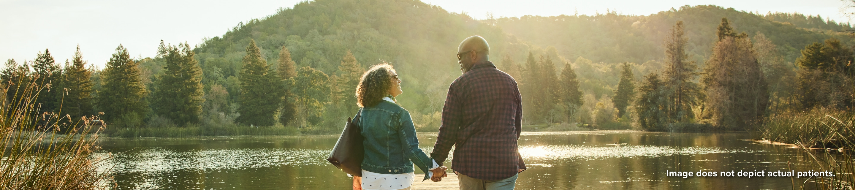 Banner image of couple holding hands lakeside